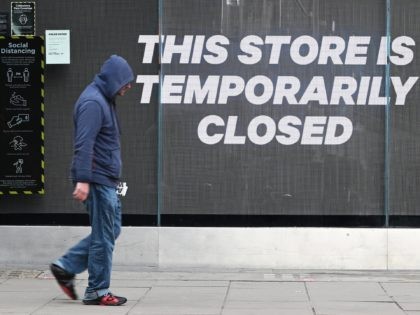 LONDON, UNITED KINGDOM - NOVEMBER 05: A man walks past a temporarily-closed clothing store on Oxford Street on November 05, 2020 in London, United Kingdom. England enters its second national coronavirus lockdown today. People are still permitted to exercise with one other person, takeaway food is permitted but bars and …