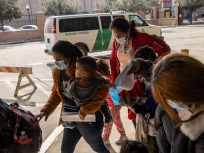 BROWNSVILLE, TEXAS - FEBRUARY 25: A family of Central American asylum seekers arrives to a bus station after being dropped off by U.S. Border Patrol agents on February 25, 2021 in Brownsville, Texas. U.S. immigration authorities are now releasing many asylum seeking families after they cross the U.S.-Mexico border and …