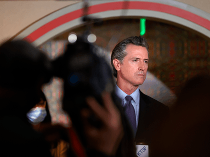 California Gov. Gavin Newsom (R) looks on during a news conference with Bay Area AAPI lead