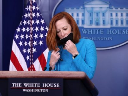 WASHINGTON, DC - MARCH 22: White House Press Secretary Jen Psaki removes her mask before talking to reporters during her daily news conference in the Brady Press Briefing room at the White House on March 22, 2021 in Washington, DC. Psaki fielded questions about U.S.-China relations, the spike in children …