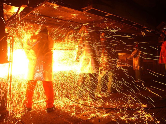 RANCHO CUCAMONGA, CA - OCTOBER 4: Casters are showered with sparks, or "skeeters," as molten steel is shaped into bars called "billets" at the TAMCO steel mini mill on October 4, 2002 in Rancho Cucamonga, California. TAMCO, California's only steel mill, has managed to persevere through skyrocketed electrical rates as …