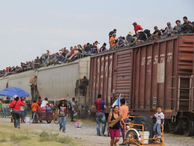 Central American immigrant get on the so-called La Bestia (The Beast) cargo train, in an attempt to reach the Mexico-US border, in Arriaga, Chiapas state, Mexico on July 16, 2014. AFP PHOTO/ELIZABETH RUIZ (Photo by ELIZABETH RUIZ / AFP) (Photo credit should read ELIZABETH RUIZ/AFP via Getty Images)