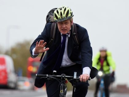LONDON, ENGLAND - NOVEMBER 19: Mayor of London Boris Johnson cycles over Vauxhall Bridge t