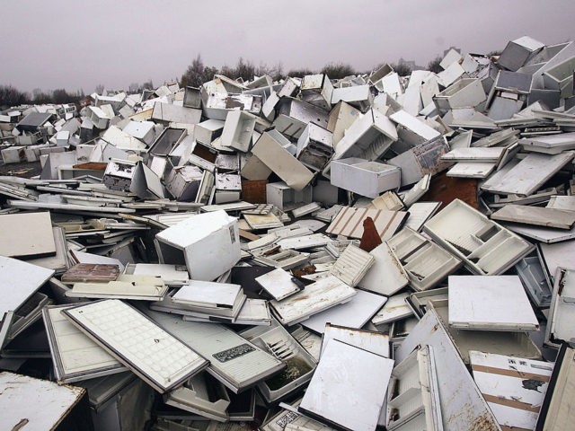 MANCHESTER, ENGLAND - NOVEMBER 24: A mountain of discarded fridges are shown at a fridge disposal site in Trafford Park Industrial area, on November 24, 2004 in Manchester, England. The firm contracted to organise the disposal went bust in March and left around 120,000 of the appliances rotting in storage.(Photo …