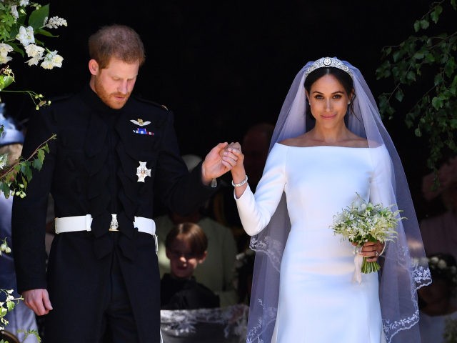 TOPSHOT - Britain's Prince Harry, Duke of Sussex and his wife Meghan, Duchess of Sussex emerge from the West Door of St George's Chapel, Windsor Castle, in Windsor, on May 19, 2018 after their wedding ceremony. (Photo by Ben STANSALL / POOL / AFP) (Photo credit should read BEN STANSALL/AFP …