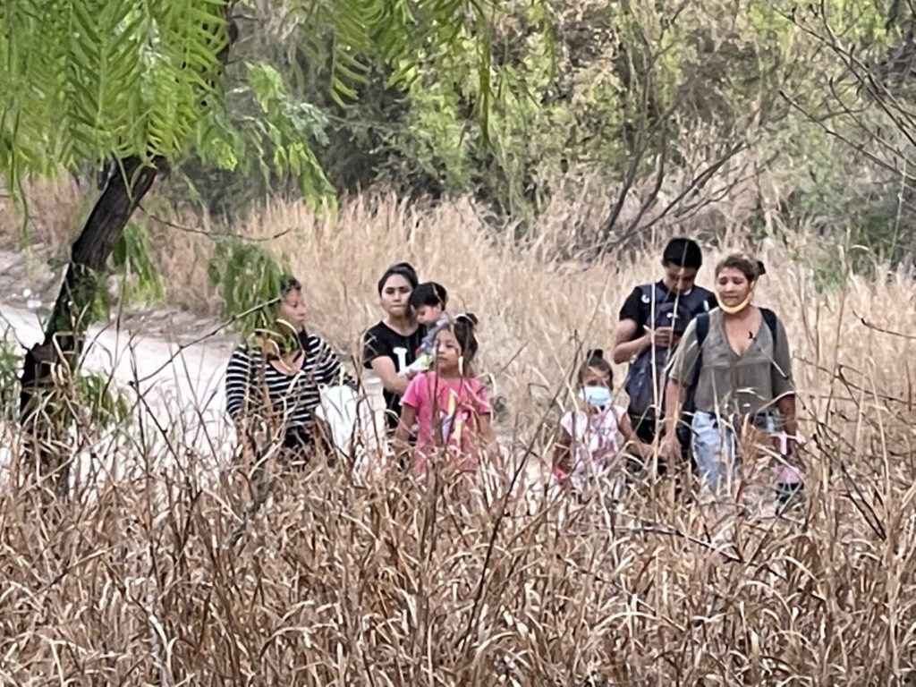 A group of migrant families search for a Border Patrol agent after crossing the Rio Grande near Mission, Texas. (Photo: Randy Clark/Breitbart Texas)