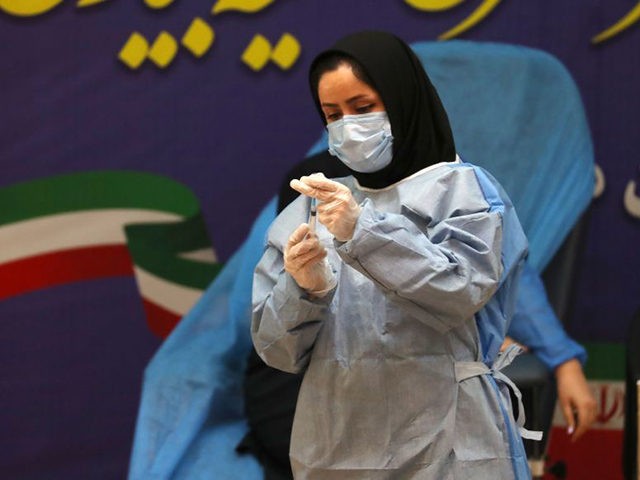 An Iranian health worker prepares a dose of the COVID-19 vaccine as the country launches its inoculation campain, at the Imam Khomeini hospital in the capital Tehran, on February, 9, 2021. - The inoculation effort for 80-million-plus population is starting with Russia's Sputnik V vaccine, authorities have said, as the …