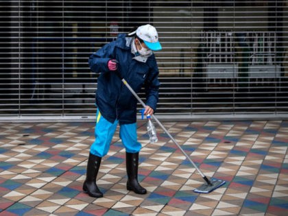 TOKYO, JAPAN - NOVEMBER 22: A cleaner mops the floor at Tokyo Dome where Pope Francis will