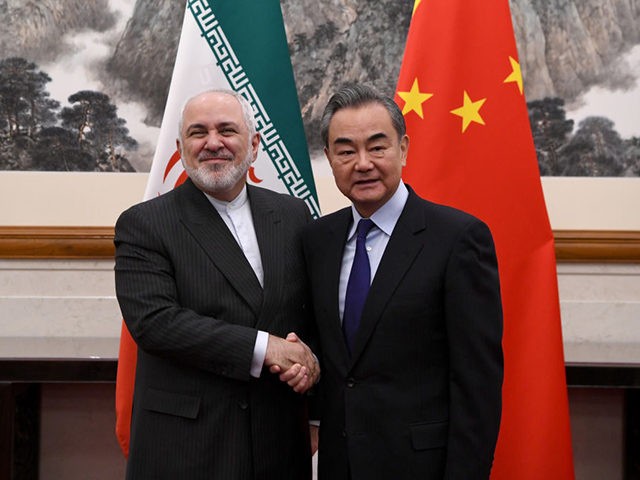 BEIJING, CHINA - DECEMBER 31: China's Foreign Minister Wang Yi shakes hands with Iran's Foreign Minister Mohammad Javad Zarif during a meeting at the Diaoyutai state guest house on December 31, 2019 in Beijing, China. (Photo by Noel Celis - Pool/Getty Images)