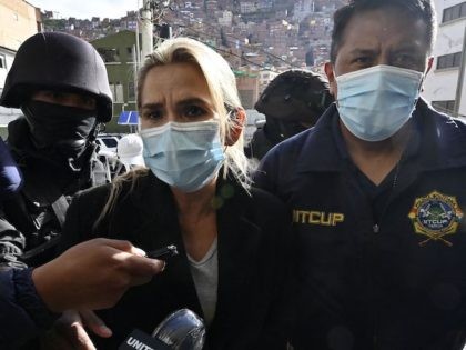 Former interim Bolivia's President Jeannine Anez (C) is escorted by police members of the Special Force against Crime (FELCC) after being arrested in La Paz, on March 13, 2021. - Bolivia's former interim president Jeanine Anez was arrested Saturday on terrorism and sedition charges over what the government claims was …