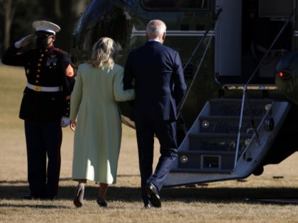 U.S. President Joe Biden and first lady Jill Biden walk on the South Lawn towards the Mari