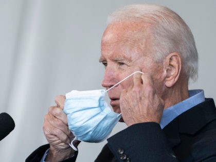 CLEVELAND, OH - NOVEMBER 02: Democratic presidential nominee Joe Biden puts on his mask after speaking at a get-out-the-vote drive-in rally at Cleveland Burke Lakefront Airport on November 02, 2020 in Cleveland, Ohio. One day before the election, Biden is campaigning in Ohio and Pennsylvania, a key battleground state that …
