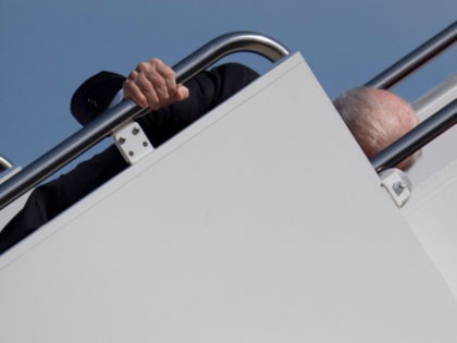 US President Joe Biden trips as he boards Air Force One at Joint Base Andrews in Maryland on March 19, 2021. - President Biden travels to Atlanta, Georgia, to tour the Centers for Disease Control and Prevention, and to meet with Georgia Asian American leaders, following the Atlanta Spa shootings. …