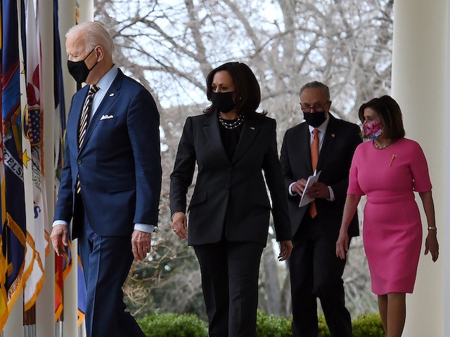 (from L) US President Joe Biden, US Vice President Kamala Harris, US Senate Majority Leader Chuck Schumer, Democrat of New York, and House Speaker Nancy Pelosi, Democrat of California, arrive for an event on the American Rescue Plan in the Rose Garden of the White House in Washington, DC, on March 12, 2021. (Olivier Douliery/AFP via Getty Images)