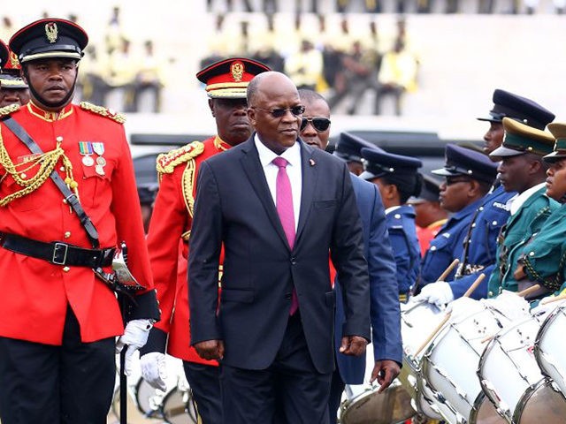 TOPSHOT - Tanzanian President John Magufuli (C-R) attends a ceremony marking the country's