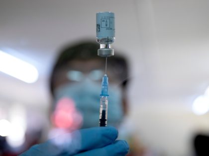 A healthcare worker fills a syringe from a vial with a dose of the Johnson & Johnson vaccine against the COVID-19 coronavirus as South Africa proceeds with its inoculation campaign at the Klerksdorp Hospital on February 18, 2021. (Photo by Phill Magakoe / AFP) (Photo by PHILL MAGAKOE/AFP via Getty …