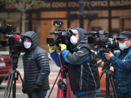 In this file photo, Journalist wearing masks document a protest where demonstrators were c