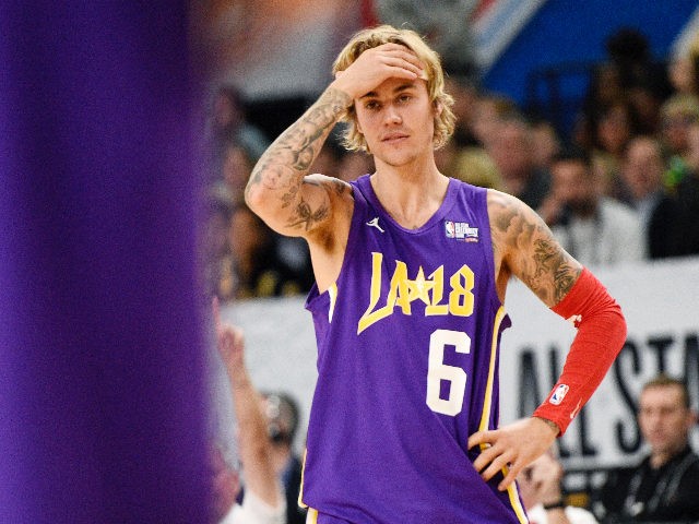 Musician Justin Bieber, of Team Lakers, reacts to a play during the NBA All-Star celebrity