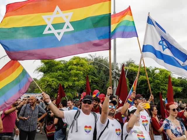 Participants wave gay rainbow pride flags during the 18th annual Jerusalem Gay Pride parad