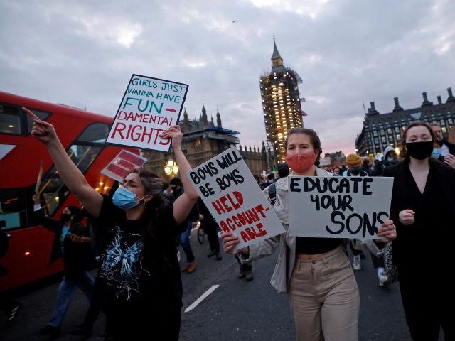 Protestors holding placards march on to Westminster Bridge as they demonstrate against the