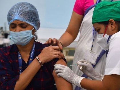 A medical worker inoculates a colleague with a Covid-19 coronavirus vaccine at the Rajawadi Hospital in Mumbai on January 16, 2021. (Indranil Mukherjee/AFP via Getty Images)