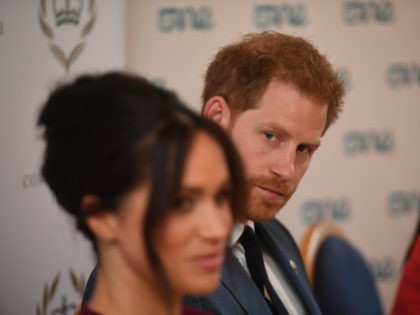 Britain's Prince Harry, Duke of Sussex (R) and Meghan, Duchess of Sussex attend a roundtable discussion on gender equality with The Queens Commonwealth Trust (QCT) and One Young World at Windsor Castle in Windsor on October 25, 2019. (Photo by Jeremy Selwyn / POOL / AFP) (Photo by JEREMY SELWYN/POOL/AFP …