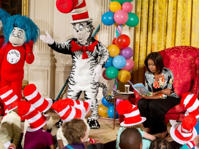 First lady Michelle Obama, with Dr. Seuss characters the Cat in the Hat, Thing 1 and Thing 2, reads to local students as part of her "Let's Move, Let's Read!" initiative, Wednesday, Jan. 21, 2015. (AP Photo/Jacquelyn Martin)