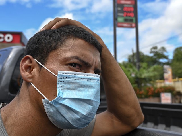 In this file photo, a Honduran migrant, who was heading in a caravan to the US, gestures after voluntarily agreeing to return to their country, in Morales, Guatemala on October 3, 2020. (Jonan Ordonez/AFP via Getty Images)