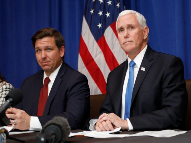 Vice President Mike Pence, right, speaks as Florida Gov. Ron DeSantis, left, looks on during a Florida Coronavirus Response Meeting, at the West Palm Beach International Airport, Friday, Feb. 28, 2020, in West Palm Beach, Fla. (AP Photo/Terry Renna)