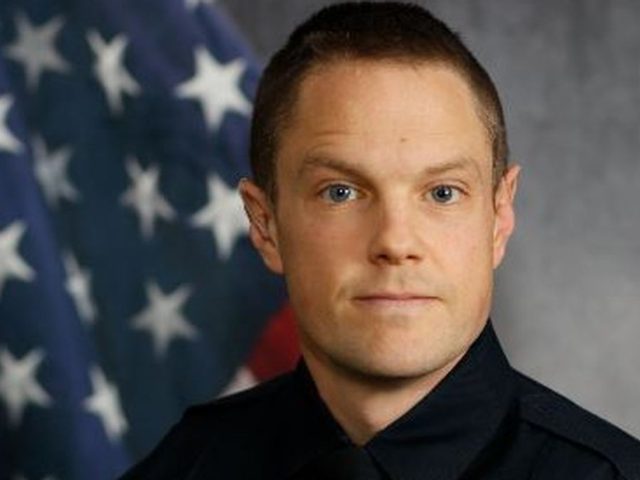 An Omaha, Nebraska, police officer is in stable condition after being shot in the top of t
