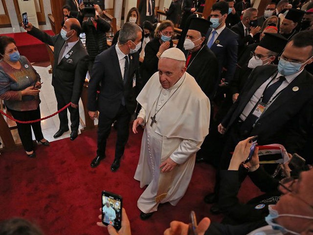 Pope Francis greets worshippers upon his arrival at the Syriac Catholic Cathedral of Our L