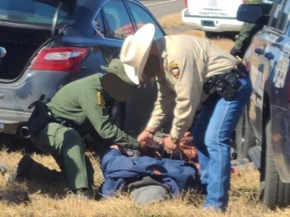 A Cotulla Station Border Patrol agent and a Frisco County Constable's Office Precinct 2 deputy place a subject under arrest following a human smuggling pursuit. (Photo: U.S. Border Patrol/Laredo Sector)
