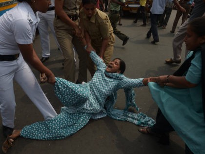 Indian police arrest activists from the Social Unity Centre of India (SUCI) organisation as they block a road during a protest against a gang rape in Kolkata on May 31, 2016. (Dibyangshu Sarkar/AFP via Getty Images)