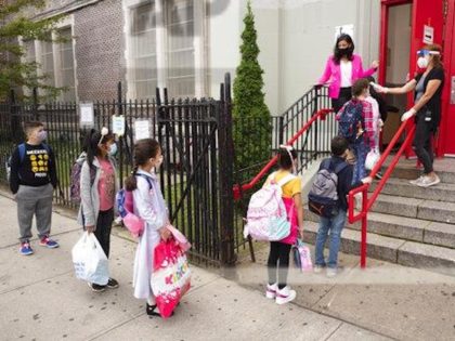 Students line up to have their temperature checked before entering PS 179 elementary school in the Kensington neighborhood, Tuesday, Sept. 29, 2020 in the Brooklyn borough of New York. (Mark Lennihan/ AP Photo)
