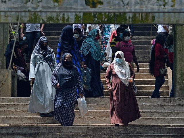 Burqa clad Muslim women climb down a flight of stairs at a zoological park on the outskirts of Colombo on March 14, 2021. (Photo by LAKRUWAN WANNIARACHCHI / AFP) (Photo by LAKRUWAN WANNIARACHCHI/AFP via Getty Images)