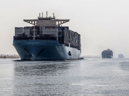 A container ship sails through the new section of the Suez Canal in the Egyptian port city of Ismailia, 135 kms northeast of the caital Cairo on October 10, 2019. - Since the Suez Canal was inaugurated amid pomp and ceremony 150 years ago, it has become one of the …