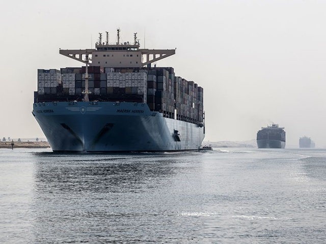 A container ship sails through the new section of the Suez Canal in the Egyptian port city