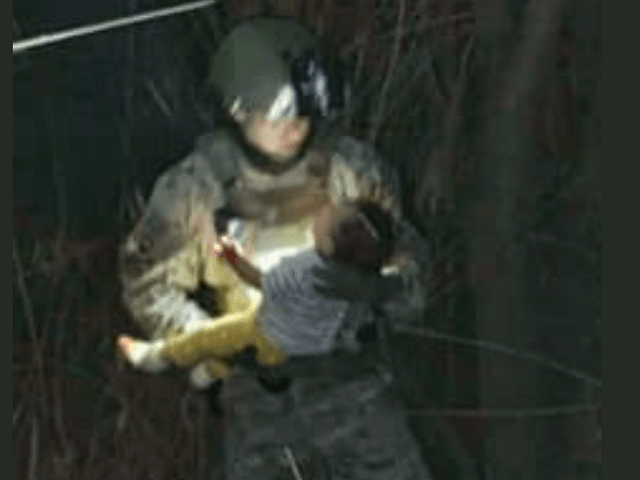 Texas Ranger carries a 6-month-old baby who was rescued after being thrown into the Rio Grande by Human Smugglers near Roma, Texas. (Photo: Texas Department of Public Safety)