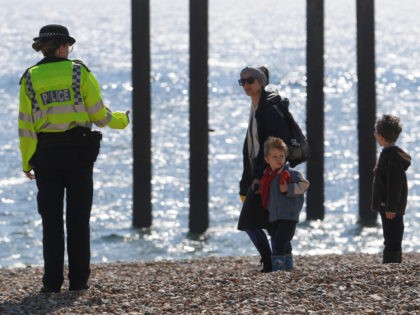 BRIGHTON, UNITED KINGDOM - APRIL 25: A police officer encourages people to leave the beach on April 25, 2020 in Brighton, United Kingdom. The British government has extended the lockdown restrictions first introduced on March 23 that are meant to slow the spread of COVID-19. (Photo by Mike Hewitt/Getty Images)