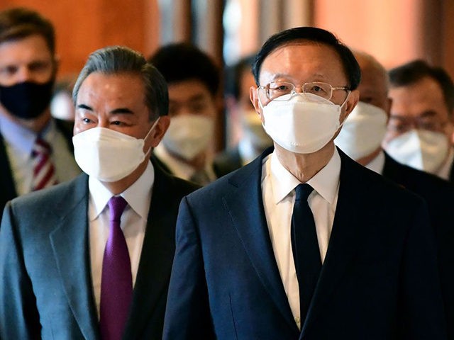 Yang Jiechi (R), director of the Central Foreign Affairs Commission Office for China and Wang Yi (L), China's Foreign Minister arrive for a meeting with US counterparts at the opening session of US-China talks at the Captain Cook Hotel in Anchorage, Alaska on March 18, 2021. - China's actions "threaten …