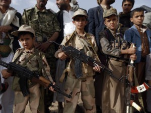 Yemeni children carrying weapons take part in a gathering organized by Shiite Huthi rebels to mobilize more fighters to battlefronts to fight pro-government forces, on June 18, 2017, in the capital Sanaa. (Mohammed Huwais/AFP via Getty Images)