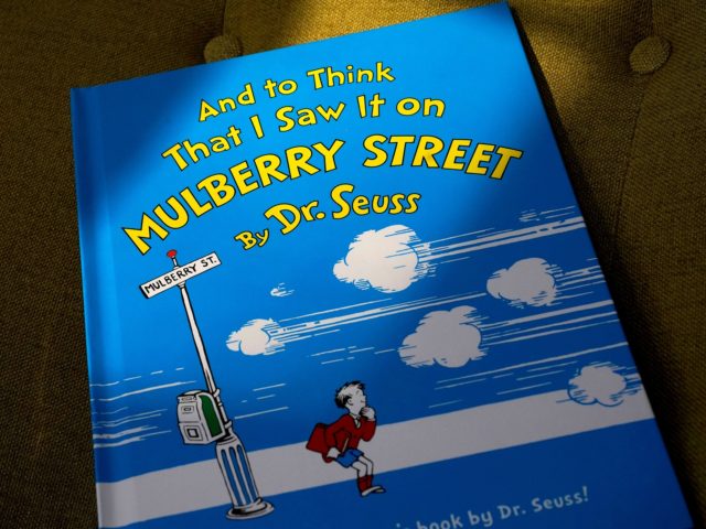 A copy of the book "And to Think That I Saw It on Mulberry Street," by Dr. Seuss, rests in a chair, Monday, March 1, 2021, in Walpole, Mass. Dr. Seuss Enterprises, the business that preserves and protects the author and illustrator's legacy, announced on his birthday, Tuesday, March 2, …