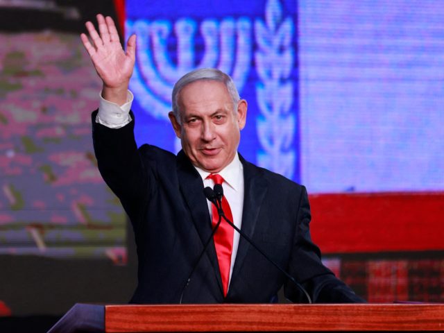 Israeli Prime Minister Benjamin Netanyahu, leader of the Likud party, waves to supporters at the party campaign headquarters in Jerusalem early on March 24, 2021, after the end of voting in the fourth national election in two years. (Photo by menahem kahana / AFP) (Photo by MENAHEM KAHANA/AFP via Getty …