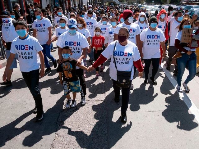 Migrants hold a demonstration demanding clearer United States migration policies, at San Ysidro crossing port in Tijuana, Baja California state, Mexico on March 2, 2021. (Guillermo Arias/AFP via Getty Images)