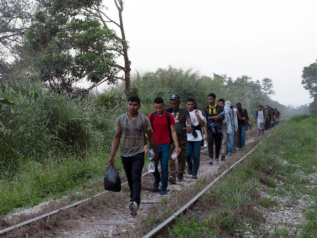 Migrants walk on train tracks on their journey from Central America to the U.S. border., in Palenque, Chiapas state, Mexico, Wednesday, Feb. 10, 2021. President Joe Biden's administration has taken steps toward rolling back some of the harshest policies of ex-President Donald Trump, but a policy remains allowing U.S. border …