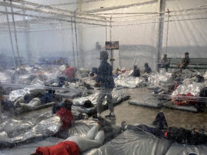 This March 20, 2021, photo provided by the Office of Rep. Henry Cuellar, D-Texas, shows detainees in a Customs and Border Protection (CBP) temporary overflow facility in Donna, Texas. President Joe Biden's administration faces mounting criticism for refusing to allow outside observers into facilities where it is detaining thousands of …