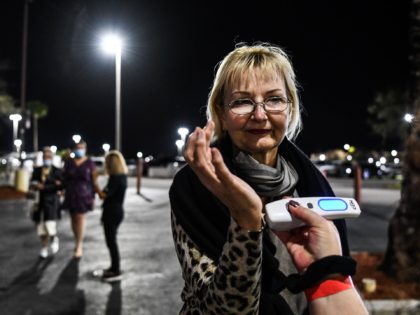 Attendees get their temperature checked as they arrive for the performance of "La Bohème"