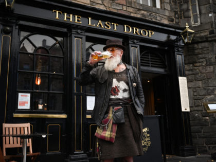 EDINBURGH, SCOTLAND - OCTOBER 07: Charles Douglas Barr enjoys a pint outside The Last Drop pub in the Grassmarket on October 7, 2020 in Edinburgh, Scotland. Scottish First Minister Nicola Sturgeon announced that pubs and restaurants across the country's central belt, including Edinburgh and Glasgow, will close from Friday at …