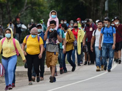 Migrants heading to the border with Guatemala on their way to the United States, march in the municipality of Santa Rita, in the Honduran department of Copan, on January 15, 2021. - Hundreds of asylum seekers are forming new migrant caravans in Honduras, planning to walk thousands of kilometers through …
