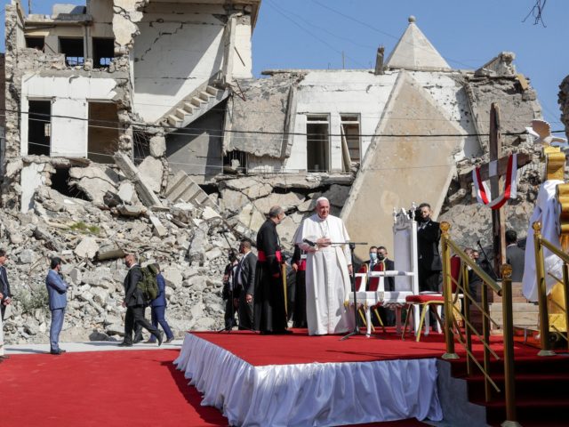 Pope Francis, surrounded by shells of destroyed churches, arrives to pray for the victims